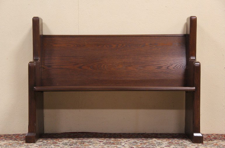 Oak 1925 Antique Carved Bench or Pew: Carved about 1925 of solid oak with a maple seat, this pew or bench has a Gothic motif at both ends. The deep lustrous finish is in excellent condition on this rugged American made antique furniture.