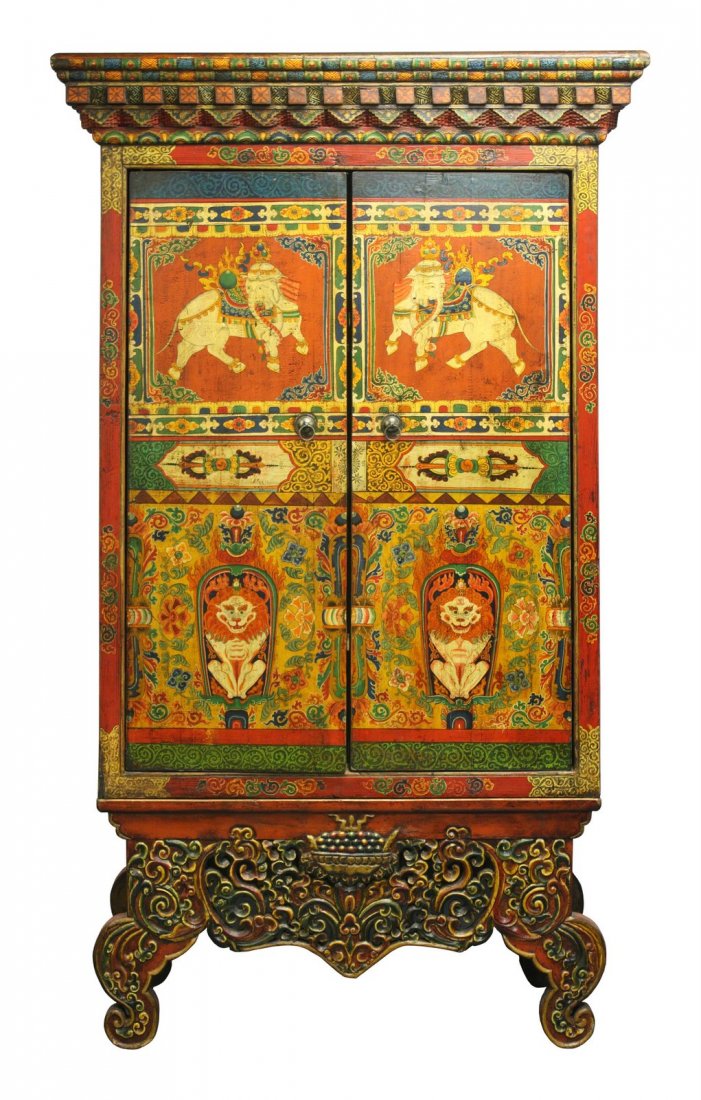 Elaborate Tibetan Cabinet with Elepants and Snow Lions: This cabinet with a crown that resembled architectural elements of Tibetan temples came from Tibetan communities in Western China. Caparisoned elephants and snow lions decorate the doors – the eleph