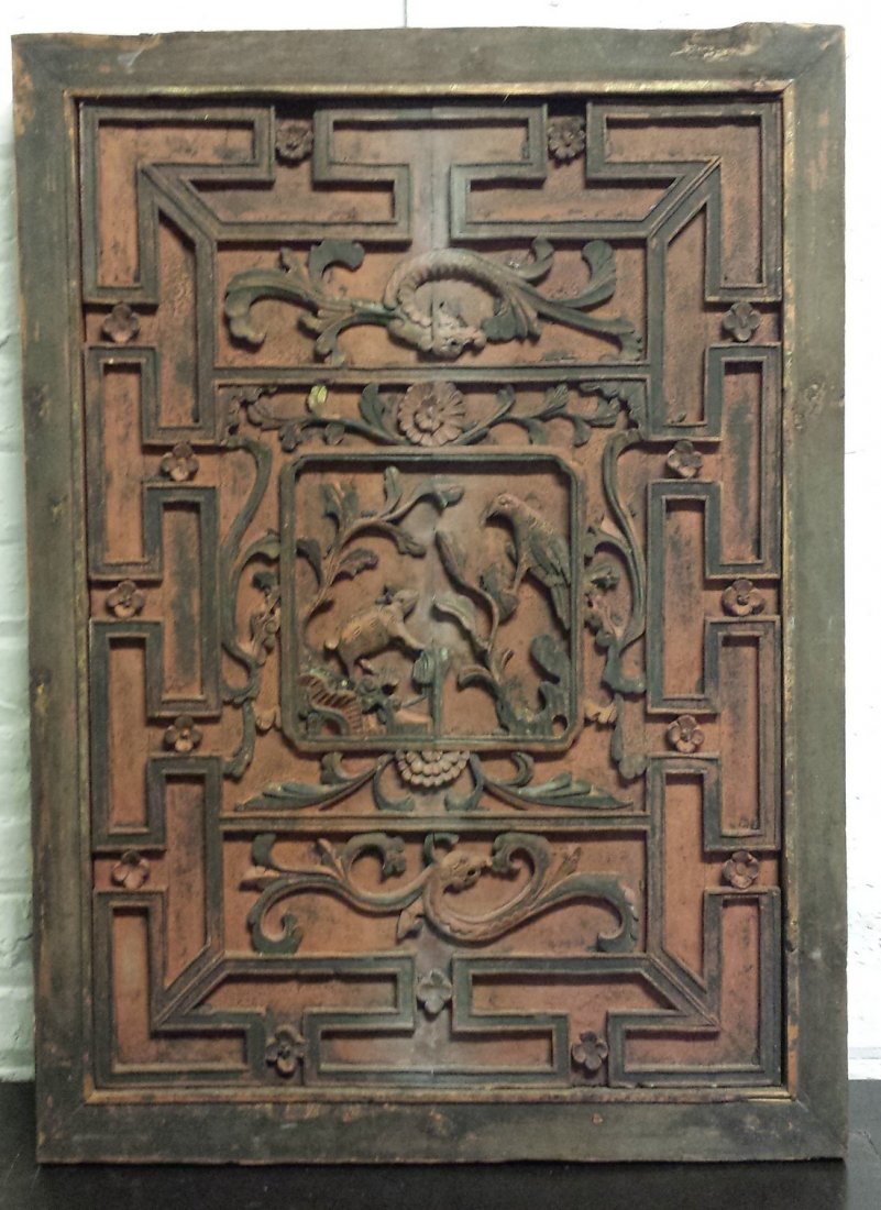 Ming Dynasty Carved Wood Panel: The panel is a piece of architectural artifact that came out of an old house. The design is a raised carving. At the center is a pictorial depiction of a bird of prey attacking animal. The presentatio