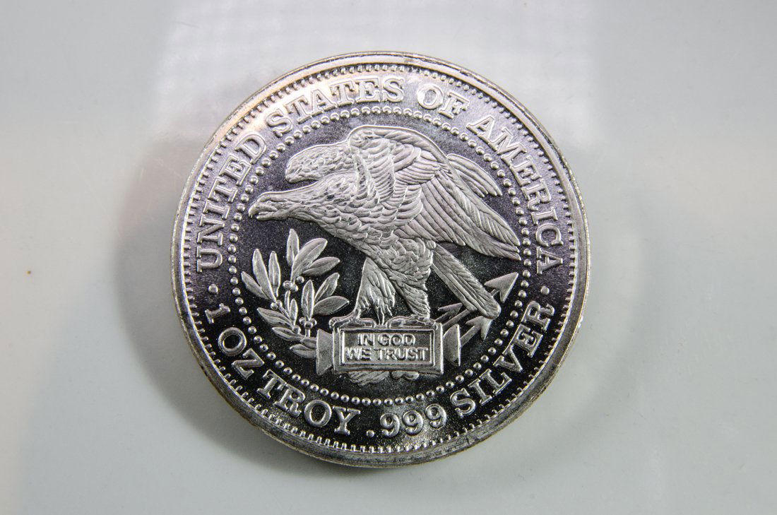 Silver Troy Coin: One ounce silver troy coin featuring American eagle and scale emblems. Measures 1.5" in diameter. FREE SHIPPING WITHIN THE USA! Will ship the item(s) within 3 days of receiving confirmation of payment