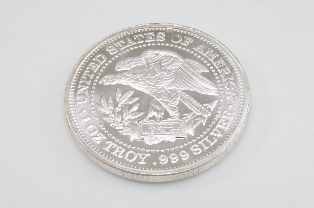 Silver Troy Coin: One ounce silver troy coin featuring American eagle and scale emblems. Measures 1.5" in diameter. FREE SHIPPING WITHIN THE USA! Will ship the item(s) within 3 days of receiving confirmation of payment