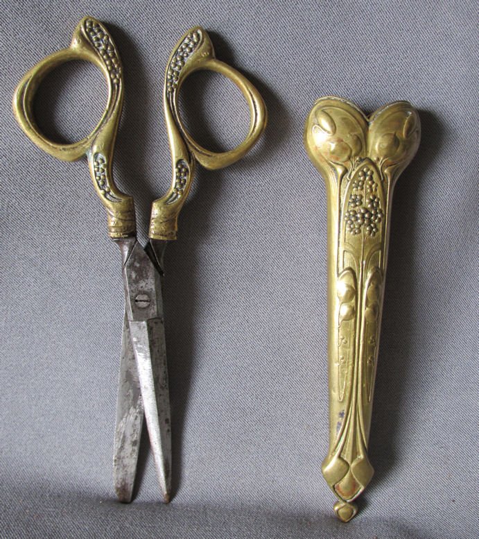 c1880s Antique Art Nouveau Jugendstil Scissors with: A pair of antique Art Nouveau, Jugendstil Desk top Scissors. The Scissors are made of brass and have steel blades, they are marked "Germany". They are complete with the original decorative sheath. Ove