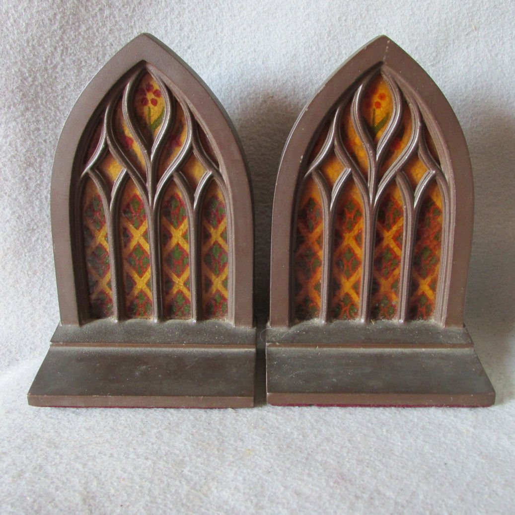 c1920s Stained Glass Window Gothic Bookends: A pair of circa 1920s Bookends. The bookends design are called "Stained Glass" and they have a pretty Gothic motif like a Church Window. They are made from spelter metal and retain the original bronze