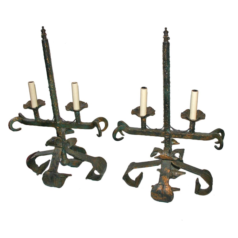 PAIR OF WROUGHT IRON LAMPS: A pair of arts and crafts Italin hammered wrought iron lamps with original verdigris finish. Rewired Measurements: 22 1/2? Height of body 15 1/2? Length 9 1/4? width This item ships from New York, NY