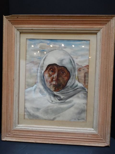 Ejnar Hansen “Old Indian Woman” P1094: Ejnar Hansen portrait of an “Old Indian Woman.” New Mexico house in background. Framed under glass. Watercolor Measurement: 25w x 29h, Image 15w x 19h. Provenance: Hansen estate This item ships fr