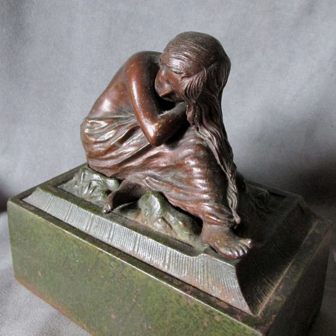 Antique Art Nouveau Nude Doorstop of Bookend: An antique Art Nouveau Doorstop or Bookends. The Doorstop has a cast iron base and the lady is spelter metal with a bronze toned finish. Overall dimensions are 6 5/8" wide x 3 5/8" deep and 6" high, s