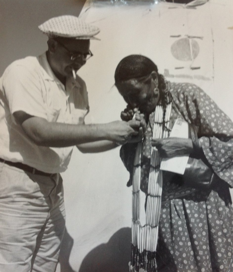 Marguerite Baker Johnson - RARE Mid Century Photograph: Photographer: Marguerite Baker Johnson Black and White Vintage Mid Century Photograph Dimensions: 8.5 x 7.5 Scene: Alice gets a store cigarette and a light Verso stamped Marguerite Johnson Marguerite 