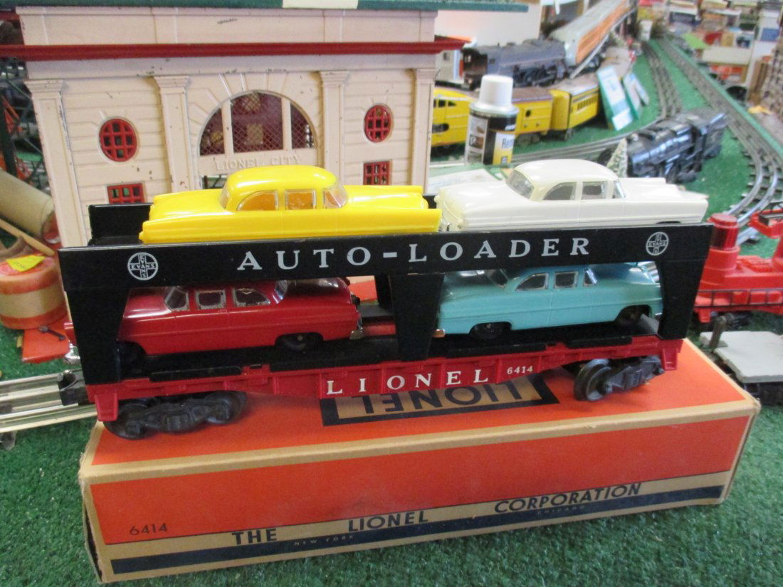 LIONEL 6414 AUTOMOBILE LOADER CAR IN ORIGINAL BOX: EXCELLENT ORIG CONDITION ALL AUTO'S ARE ORIG POST WAR & IN GREAT COND 1 ISSUE, THE WHITE CAR IS MISSING A CORNER OF THE REAR BUMPER LOADE IS EXC. HAS ALL STEPS AND BREAK STAND DIE CAST TRUCKS OPERATIN