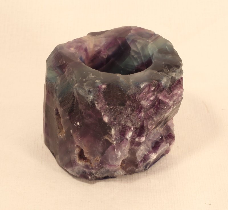 fluorite votive/tealight holders large almost 2 pounds: fluorite votive/tealight holders are large, heavy (about 2 pounds each) and gorgeous. Each is a different bands of color that, when lit, looks like a rainbow of color. A wonderful gift or home decor p