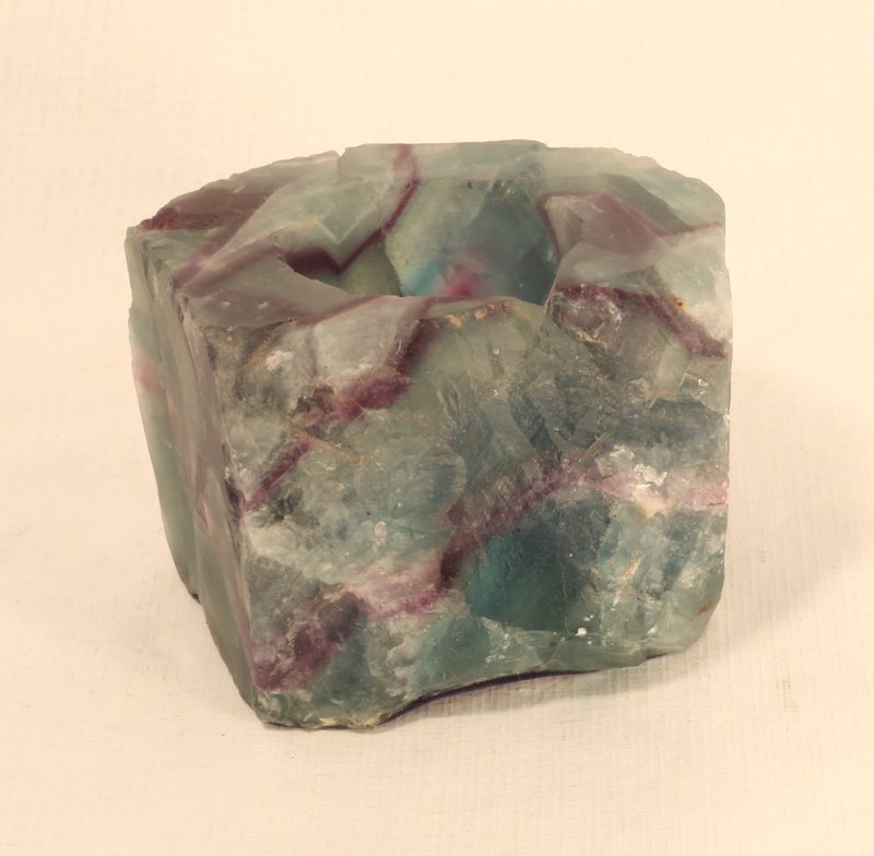 fluorite votive/tealight holders large almost 2 pounds: fluorite votive/tealight holders are large, heavy (about 2 pounds each) and gorgeous. Each is a different bands of color that, when lit, looks like a rainbow of color. A wonderful gift or home decor p