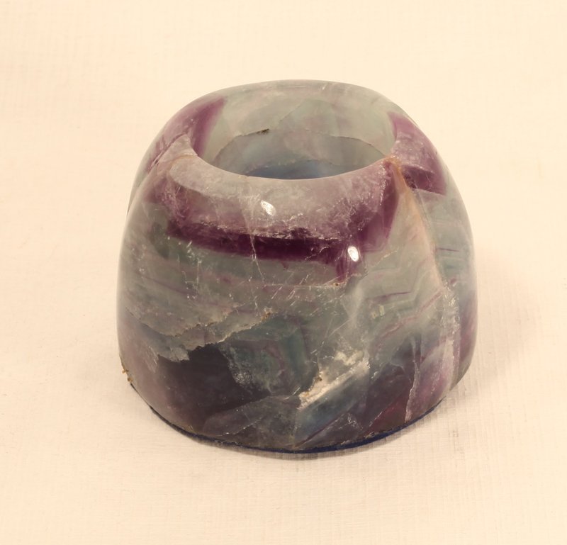 fluorite votive/tealight holders large almost 2 pounds: fluorite votive/tealight holders are large, heavy (about 2 pounds each) and gorgeous. Each is a different bands of color that, when lit, looks like a rainbow of color. A wonderful gift or home decor p