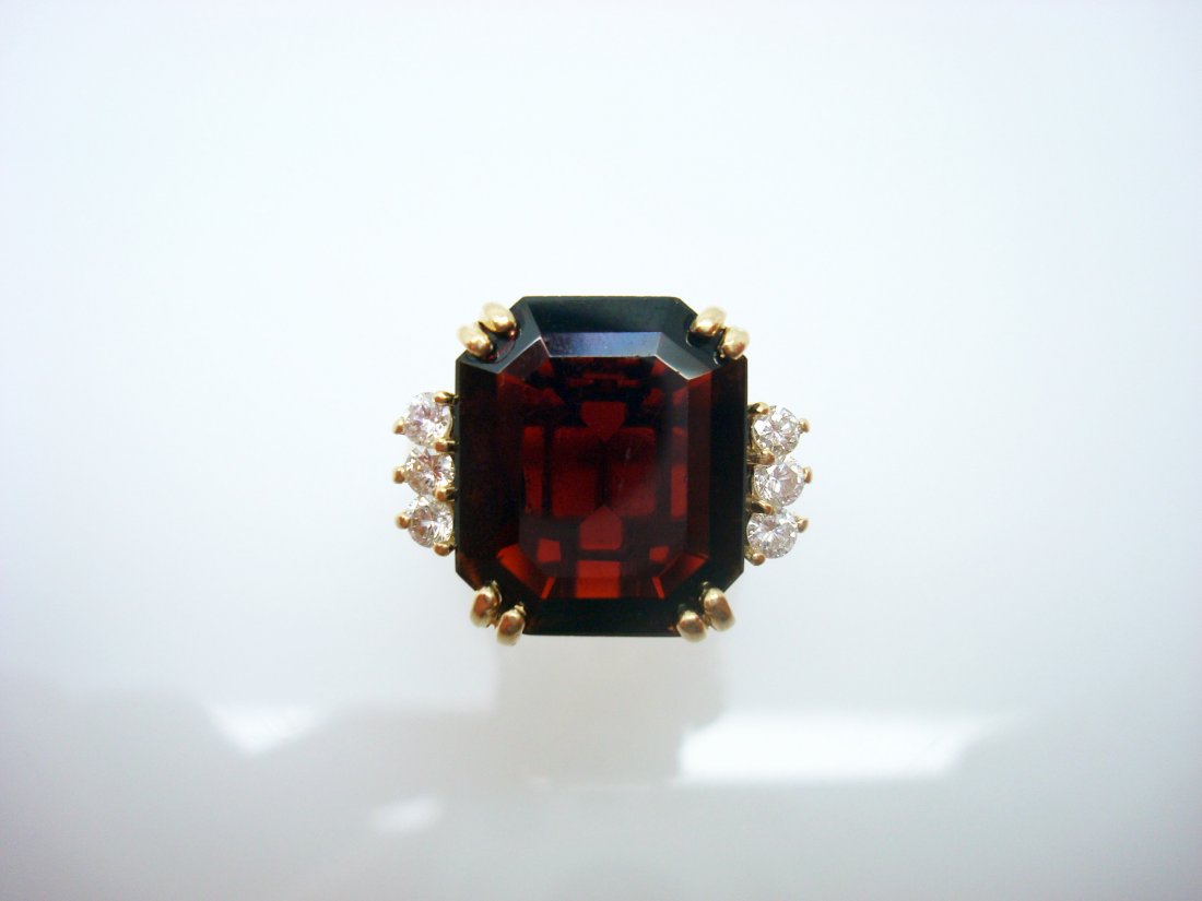 14K ring with 7.11 carat Garnet and diamonds: step cut garnet measures 14mm x 11.3mm and weighs 7.11 carats, 6 round brilliant cut diamonds measure 2mm with total weight of approx .30ct, size 7 finger, weighs 3.6dwt No Reserve Free shipping for t