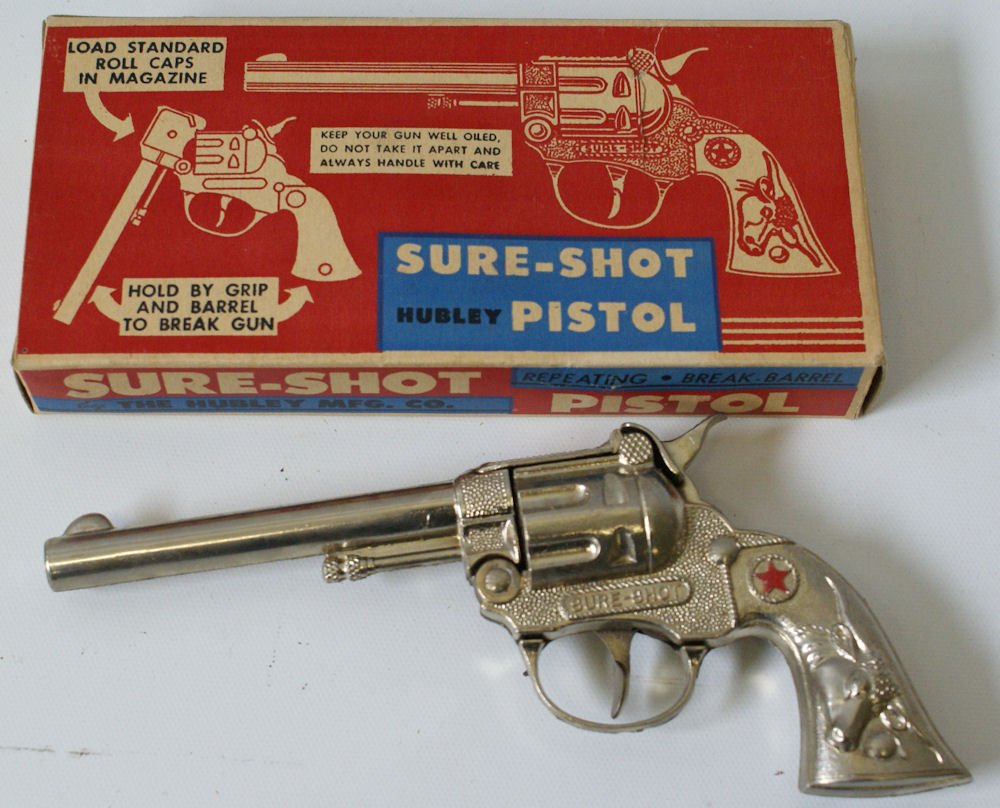 Vintage #230 HUBLEY Sure-Shot Cap Pistol Gun in: Vintage #230 HUBLEY Sure-Shot Cap Pistol Gun in original box. Features all metal, repeating, break-barrel, and shoots standard roll caps. Gun measures 7" long. Mint condition in the original box. Woul