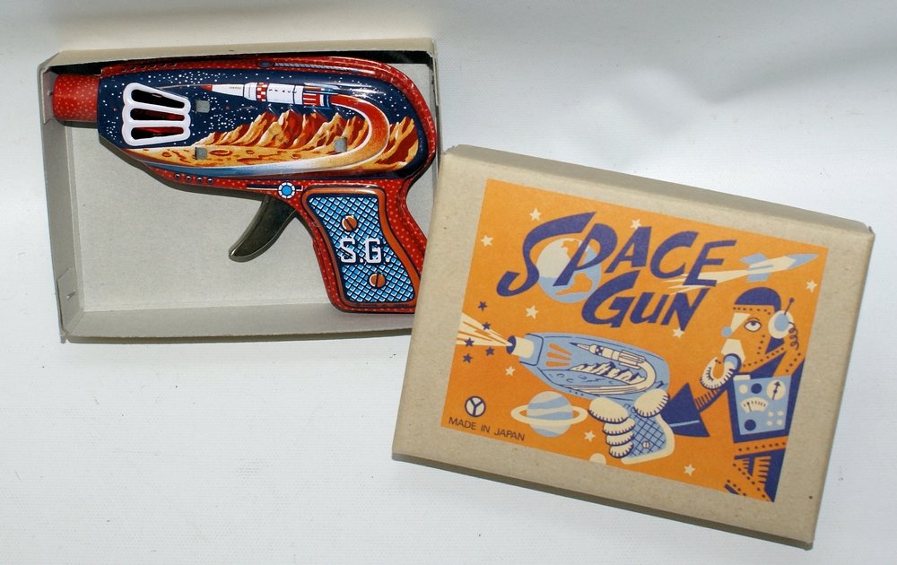 Vintage YONEZAWA Japan Tin Litho Friction Sparkling: Vintage YONEZAWA Japan Tin Lithographed Friction Sparkling SPACE RAY GUN S.G., in the original box. Original old store stock. A fabulous ray gun with a space planet scene with a rocket ship. Perfect w