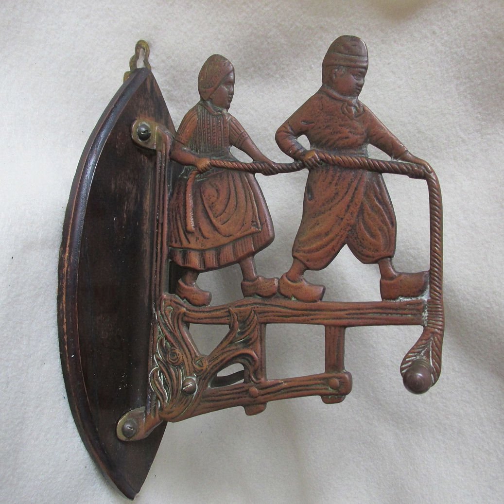 Art Nouveau Wall Hook with Dutch Children: An antique Art Nouveau wall hook in the figural form of Children. The Children are Dutch and are pulling a rope, there is a hook on the end, the side has a small "c" shaped hook and the back board is 