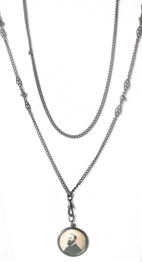 Antique 60-Inch Gunmetal Chain With Two-Sided Photo: Antique 60-Inch Gunmetal Chain With Locket Circa. 1900-1909 American. . 60 Inch gunmetal chain with small round gunmetal bead and flat marquis shaped detail on each side of bead (see photos). Double l