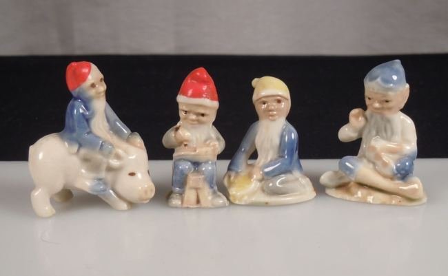 4 Wade Leprechaun Figurines: Four porcelain leprechaun figurines made by Wade. They stand between 1.5" and 1.75" and are in excellent condition. No Reserve Free shipping for this item within the continental US.