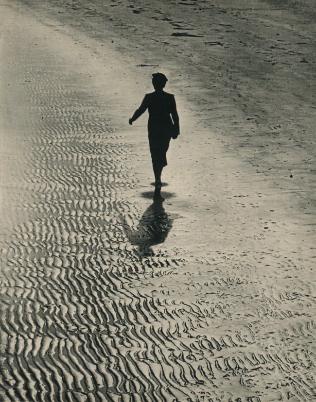 Eisenstaedt, Alfred - Girl Walking on Beach: 1937 Sheet-fed Gravure printed in New York - Image Size approx. 10" x 13" Shipping Domestic: $15 shipping within the Continental USA. International: Additional shipping charges will apply. Location: I