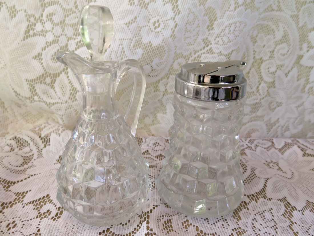 Fostoria American Syrup & Cruet: This lot includes (2) Fostoria American pieces Including a Drip Cup Syrup Pitcher and a Cruet with Stopper. The Cruet measures 6 1/2" Tall to the Top of the Stopper. No Reserve Buyer pays $28 flat rat