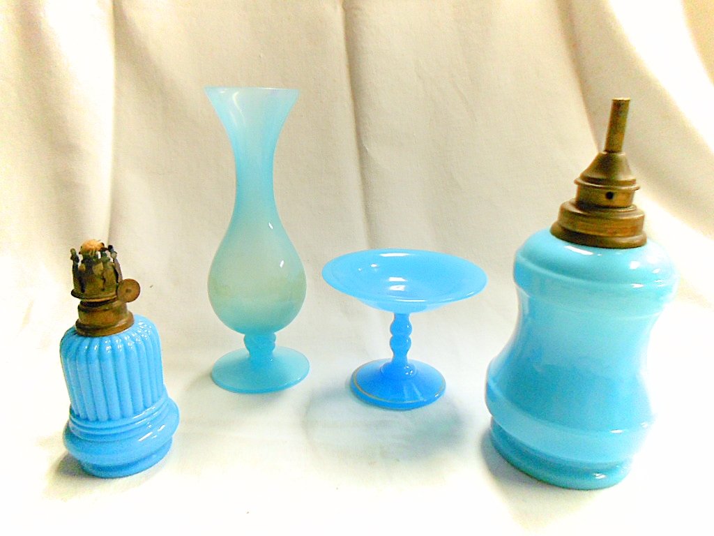 4 Piece Dealer Lot French Aqua Blue Opaline: 700g. Large lamp - 7 1/4" tall X 3 1/2" diameter at widest. Small lamp - 4 1/2" tall X 2 1/4" diameter. Bud vase - 7 1/8" tall X 2 1/8" diameter at rim. Compote - 3" tall X 4" diameter at rim