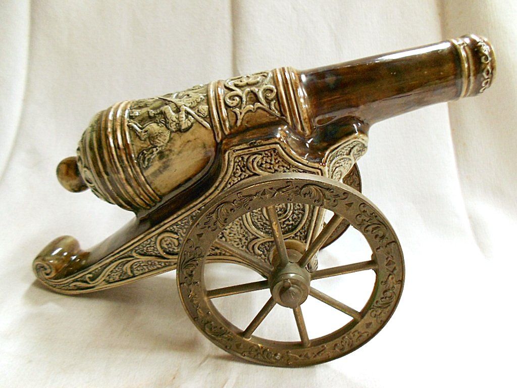 French Cannon Liquor Bottle: 1438g. 7 1/4" tall X 11" long X 5 1/2" wide. Excellent condition with just a few light scratches. Made of Ceramic & metal. No Reserve US domestic shipping is $24 for this item. International shi