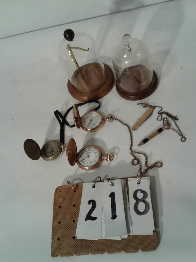 (2) Pocket Waltham Watches & Pocket Compass: (1)Waltham 1890s gold filled pocket watch (cracked glass, running) It works with knife + pencil, fob with attached hand, with plastic dome with wood base; (1)fancy American Waltham with stag on case w