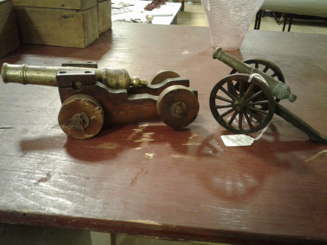 (2) Miniature Solid Brass Vintage Cannons: (2) miniature, usable solid brass vintage cannons - (1)Largers 10"L x 5"W(1 wheel has wood damge and brass cannon has been fired); (1) 8 1/2"L x 3 3/4"W (this has been fired). (sold as a pair)