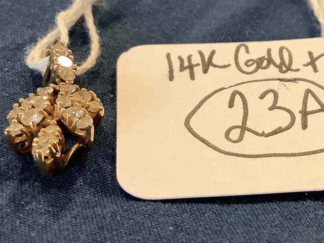 14K Gold and Diamond Locket: 14K gold and diamond locket in the shape of a leaf. Each of the 4 branches has 4 diamonds with 3 diamonds on the stem (19 diamonds total). Acid tested/guaranteed. 1.2 dwt of 14K (1.8 grams)