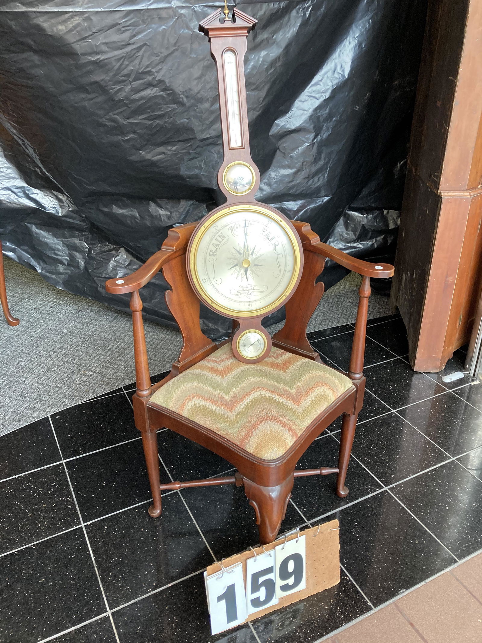 Walnut Chair and Mahogany Barometer: (1) Solid walnut contemporary corner upholstered chair. 33"h x 25"w x 23"d. (1) Mahogany Air Guide Barometer. Marked Jeweled Instrument Co., Chicago. 38.5"h x 13.5"w. Unreserved from the Conyngham, PA
