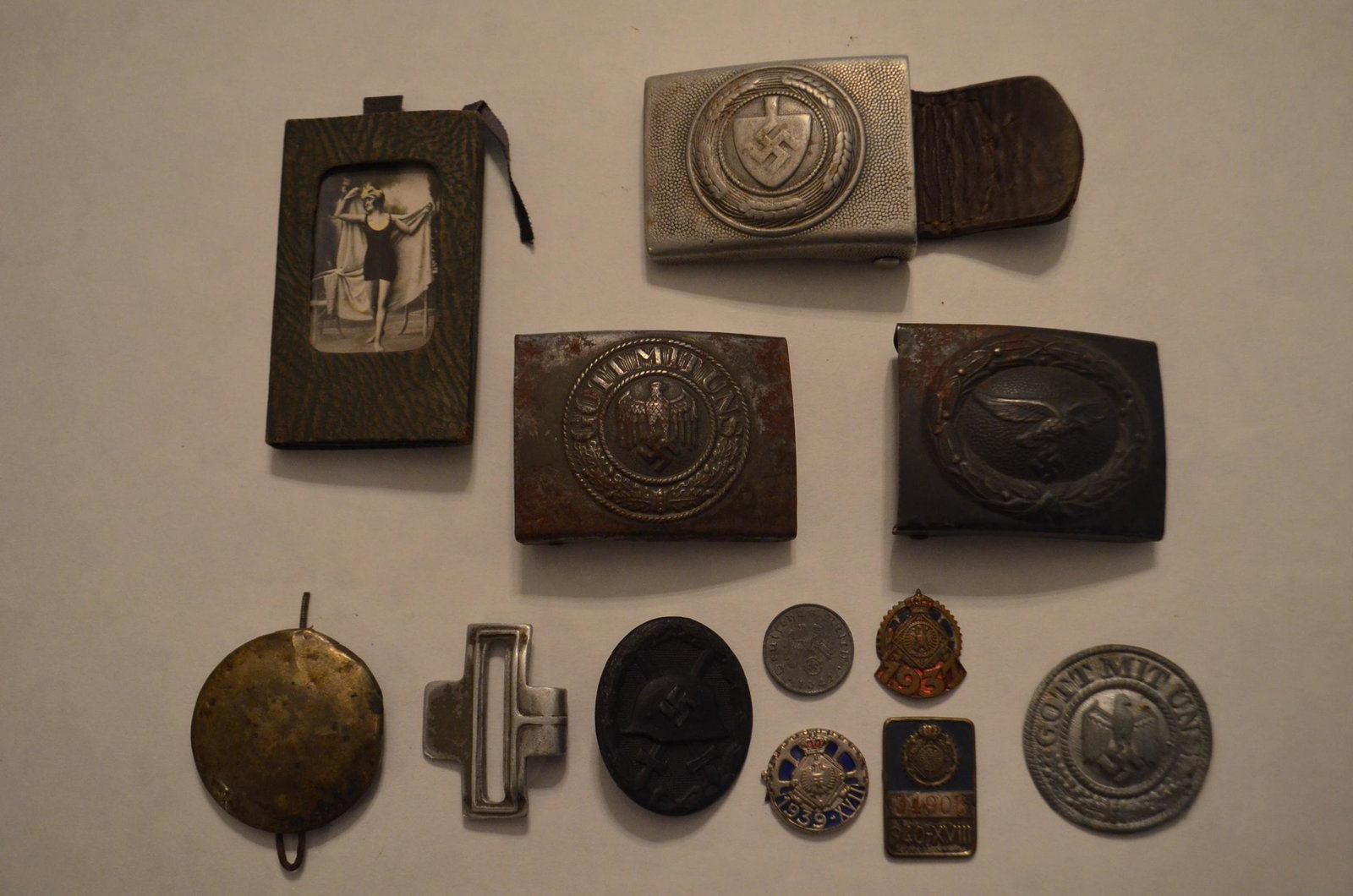 10+ Nazi WWII German Items: 10+ Nazi WWII German Items. Belt buckles, pins, coins, photo, etc. See photos. From the Cape Vincent, NY Estate.