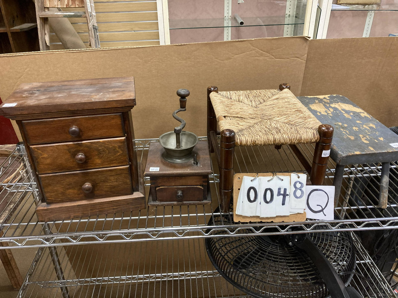 Lot of Four Antique Items: Lot of four antique items. (1) 3 drawer miniature 1900s chest. (1) 19c dovetailed coffee grinder (as is). (1) 1830s grey paint milk stool. (1) 1900s Mottville, NY foot stool. From the Norwich, NY Esta