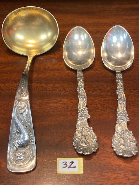 Three Antique Pieces of Fancy Sterling Silver: Three antique pieces of exceptionally fancy handled sterling silver serving pieces to include: (2) Gorham female figured large sterling silver serving spoons and (1) Dolphin handled sterling silver to