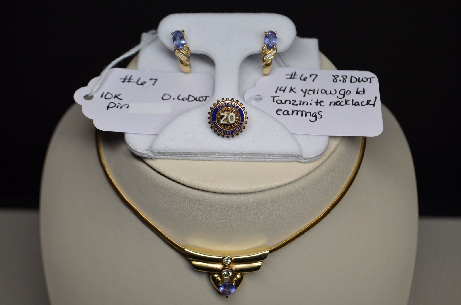 14K Gold Necklace & Earrings and 10K Pin: Matching 14K yellow gold tanzanite necklace and earrings. Necklace is 16"l. 8.8 dwt total weight including stones. 10K yellow gold pin stating "20 Year Rotary 100% Attendance". It is an honor to sell 