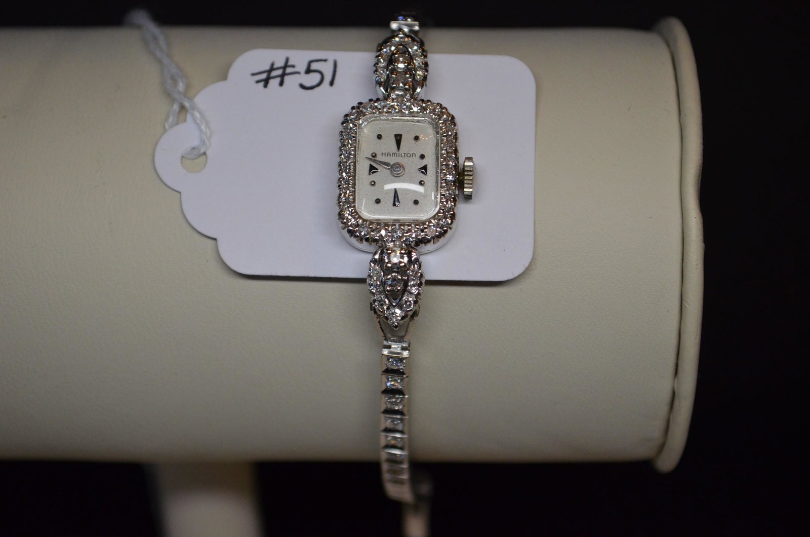 Ladies 14K White Gold Diamond Encrusted Watch: Excepetional ladies 14K white gold (housing and band) diamond encrusted watch with 17 jewel stem wind, stem set Hamilton movement. White gold housing has the number two 0.05 ct. single-cut diamonds, t