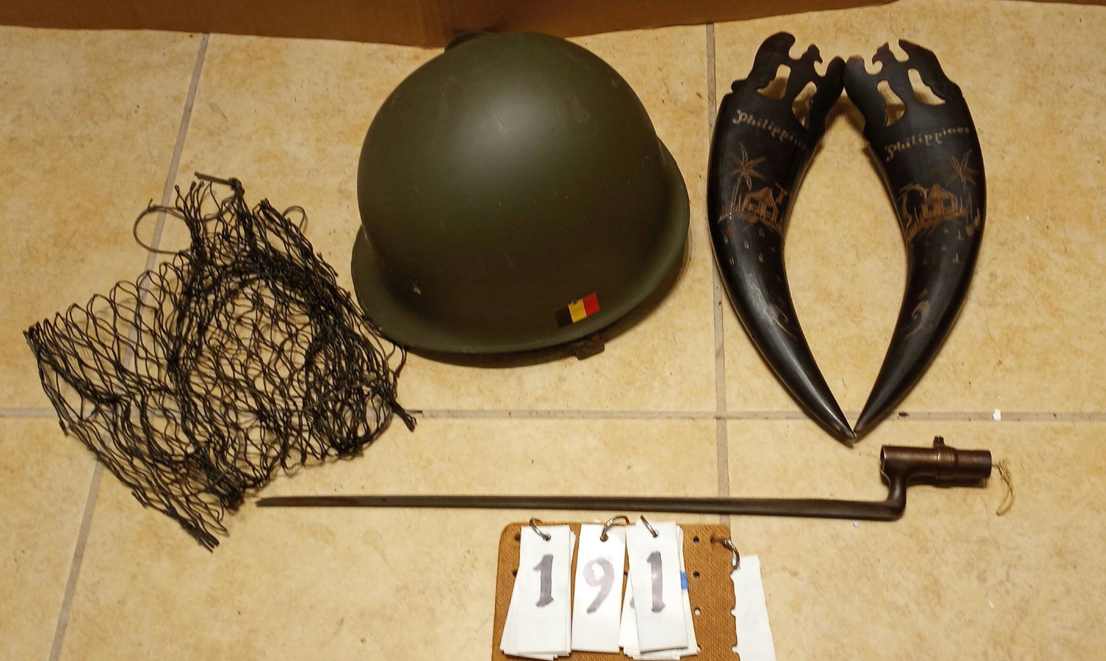19c Bayonet and Korean War Soldier Helmets: Five items to include: (2) Korean War soldiers helmet with insert, (1) 19c bayonet, (2) horns engraved Philippines with an eagle. The helmets are 11"l x 9"w x 5.5"d. The bayonet is 23.75"l (18" is the