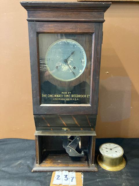 Two Antique Clocks: Two antique clocks. (1) Schatz Royal Mariner brass ships clock. Manufactured in Germany. Missing some brass trim and has no key. Unknown if it works. 5" dia. x 3"h. (1) Cincinnati Time Recorder Co. cl