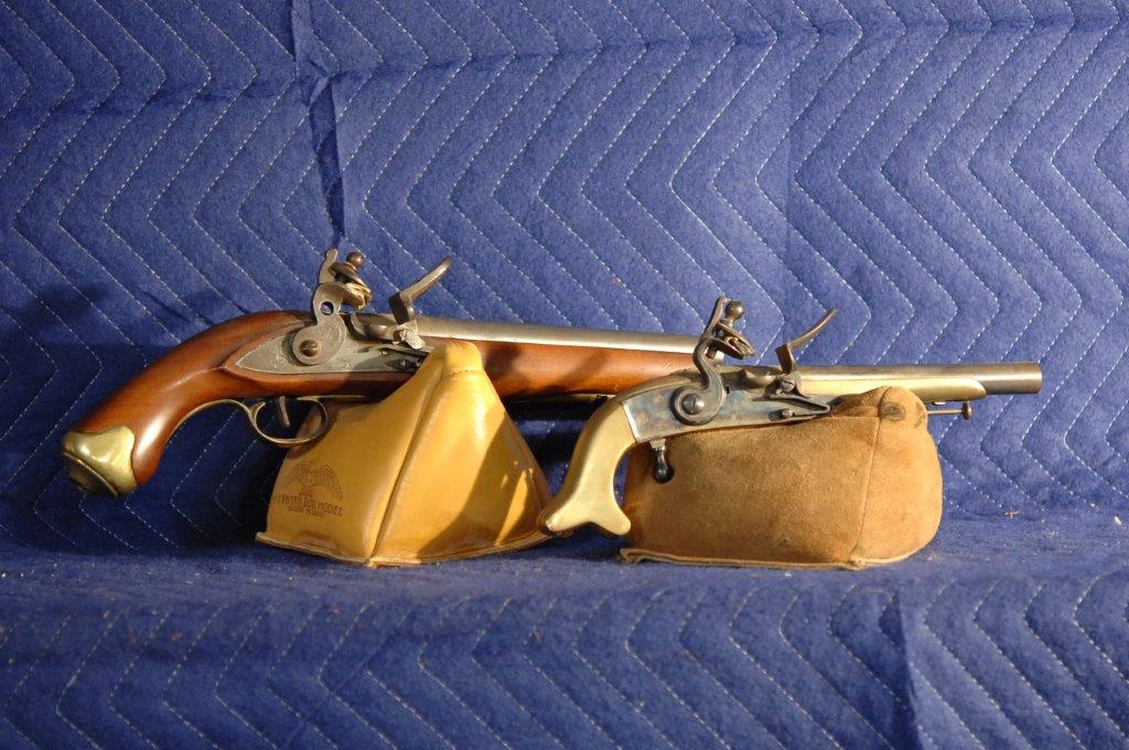 Two Black Powder Flint Lock Pistols: Two black powder flint lock pistols. Reproductions. 69 cal. and 58 cal. No serial numbers, no FFL needed.
