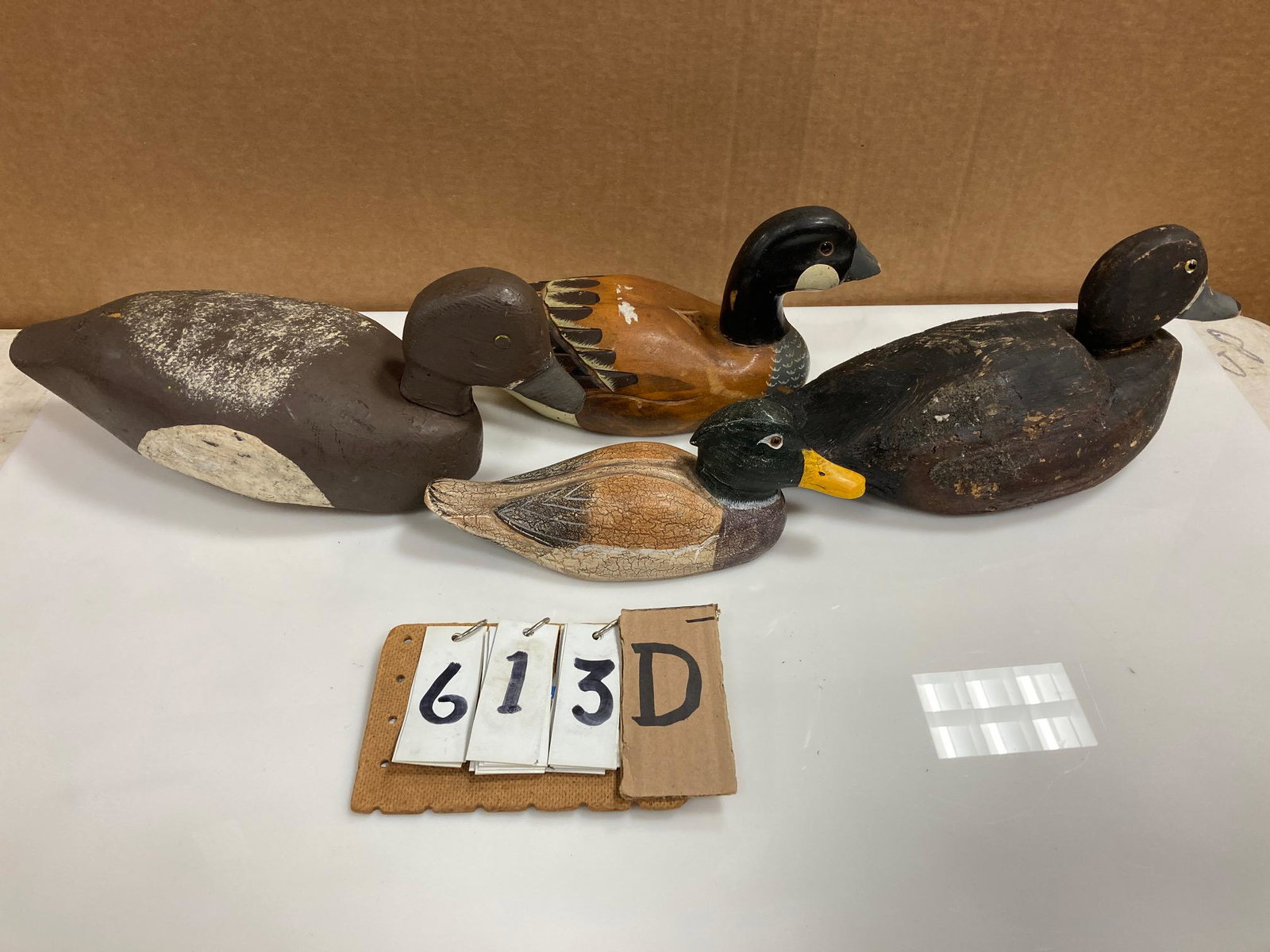Four Hand Carved Wood Duck Decoys: Four hand carved and hand painted wood duck decoys. Includes two bluebill hens, one miniature mallard drake and one miniature Canada goose. From the collection of one family in St. Lawrence County, NY