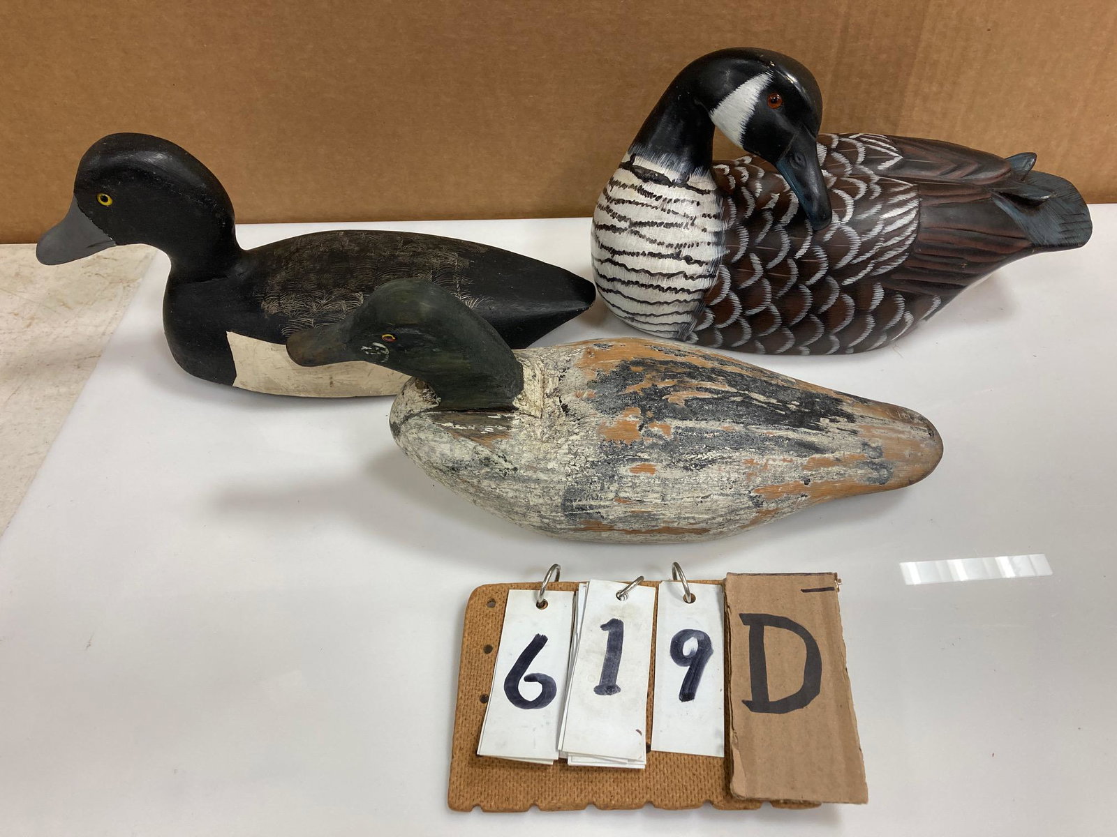 Three Hand Carved Wood Duck Decoys: Three hand carved and hand painted wood duck decoys. Includes one mallard duck, one sleeping goose and one bluebill drake carved by Ed Rion of Ogdensburg, NY. From the collection of one family in St. 