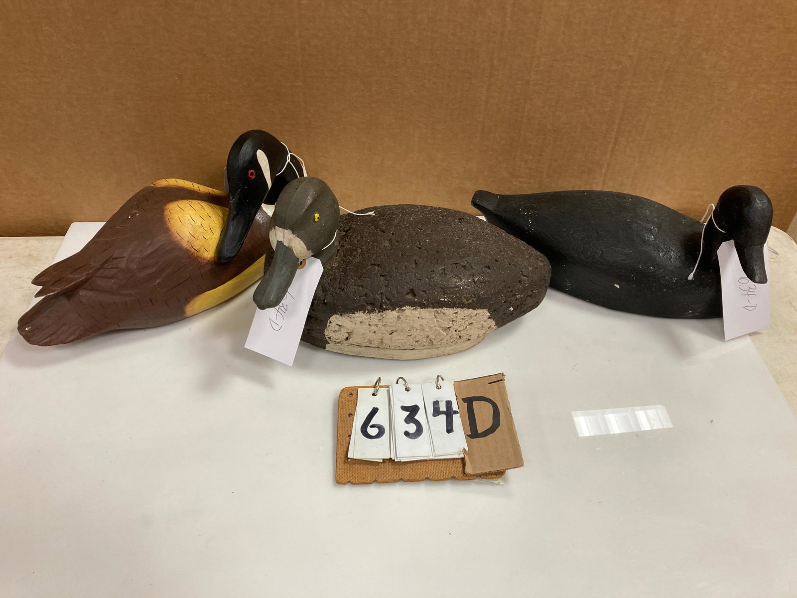Three Hand Carved Wood Duck Decoys: Three hand carved and hand painted wood duck decoys. Includes one sleeping Canada goose, one cork bodied bluebill hen and one mallard drake. From the collection of one family in St. Lawrence County, N
