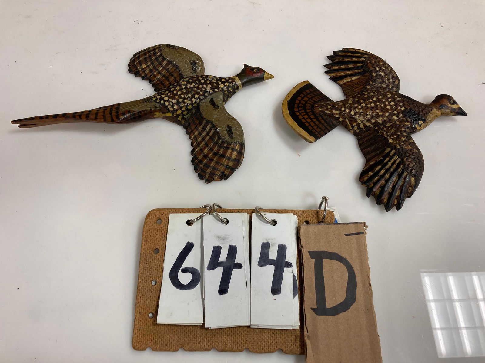 Two Hand Carved Wall Decoys: Two nicely done hand carved and hand painted very early wall plaque decoys of a cock pheasant and a flying roughed grouse. 10.125" x 6.75" and 7" x 7". From the collection of one family in St. Lawrenc