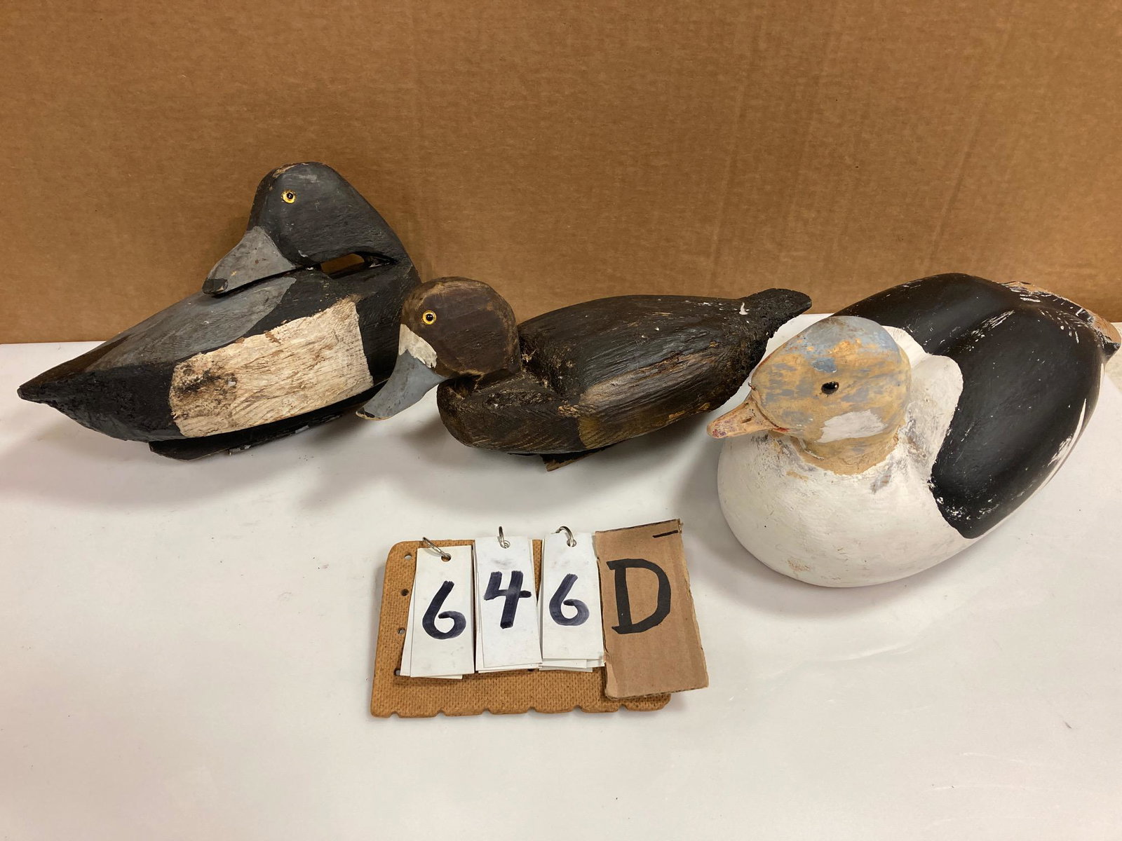 Three Hand Carved Wood Duck Decoys: Three hand carved and hand painted wood duck decoys. Includes one sleeping bluebill drake, one bluebill hen and one bufflehead drake. From the collection of one family in St. Lawrence County, NY who l
