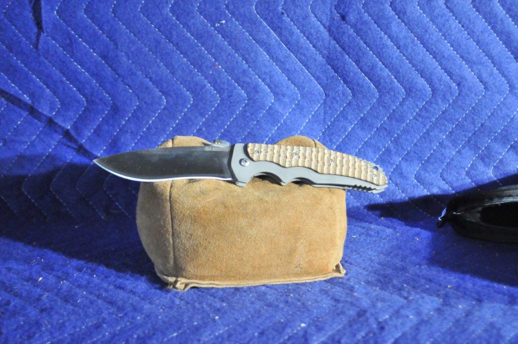 Signed R.J. Martin Avenger Folding Knife: Signed R.J. Martin Avenger Folding Knife. 4.25" blade length, 9.5" overall length. Framelength folder, CPMS30V Rc60, Titanium frame, textured tan canvas micarta overlays.