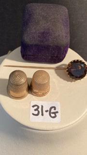 Two 10K Gold Thimbles and One 10K Gold Stick Pin: Two 10K gold thimbles and one 10K gold stick pin. 8.6 dwt total weight. Please read the Terms and Conditions of this auction thoroughly for IMPORTANT bidder information.