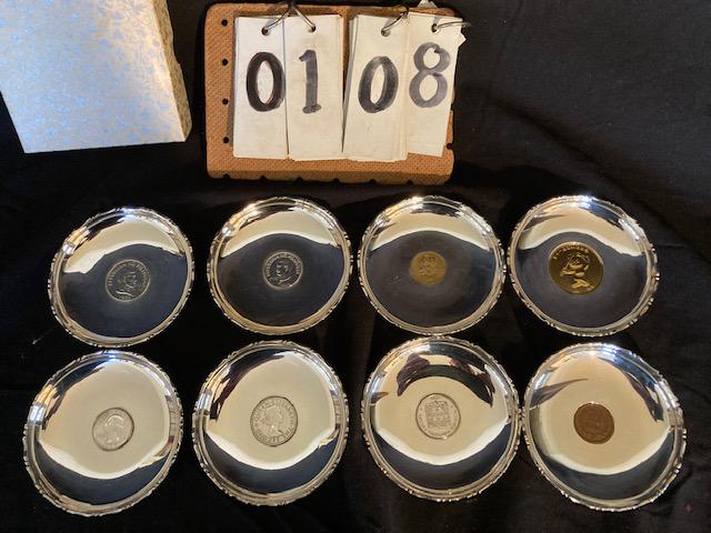 Eight Sterling Silver Plates/Coasters with Coins: Eight sterling silver plates/coasters with coins in them. WAI KEE. 11.45 troy oz. total weight (including coins). Please read the Terms and Conditions of this auction thoroughly for IMPORTANT bidder i