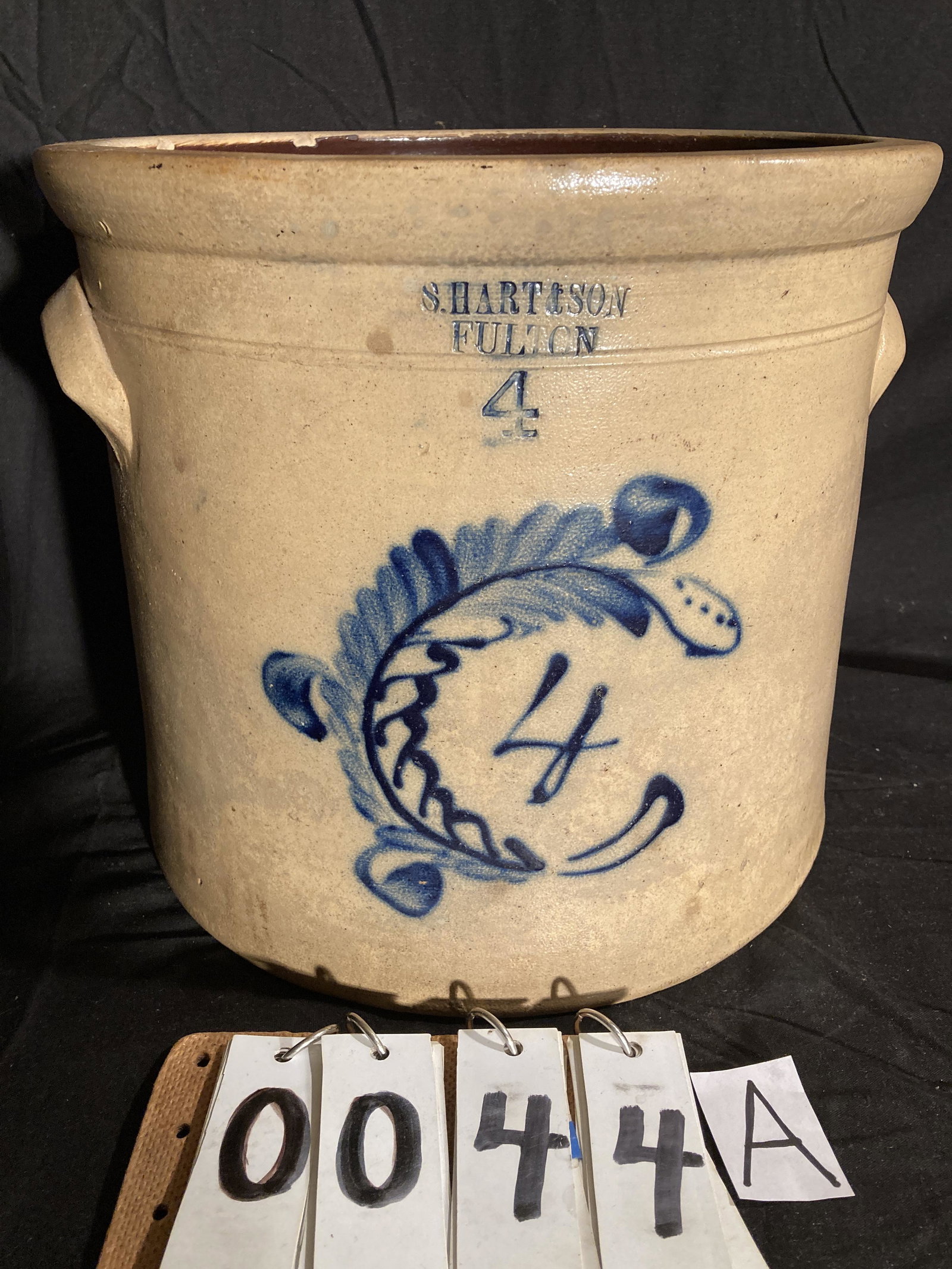 S. Hart & Son 1800s Fulton, NY 4 Gallon Crock: S. Hart & Son 1800s Fulton, NY 4 Gallon Crock with Wreath Design. Stoneware crock, 2 chips on the left handle 13 1/2" d x 11" h