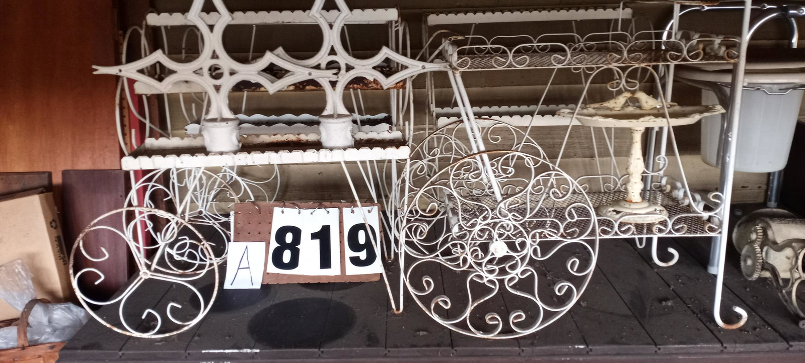 Seven Miscellaneous Metal Wire Pieces: Seven miscellaneous metal wire pieces. Three wire three-tier plant stands, one wire tea cart, two iron post finials an one iron double bird table and bird bath. Please read the Terms and Conditions of