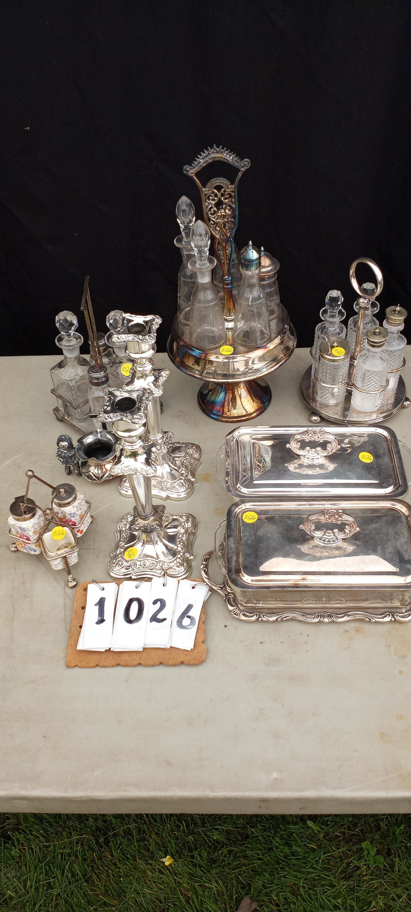 19c and 20c Silver Plate Items: 19th century and 20th century silver plate items. Includes four silver plate 19th century castor sets, two silver plate serving dishes, two antique silver plate candlesticks and one Buster Brown match