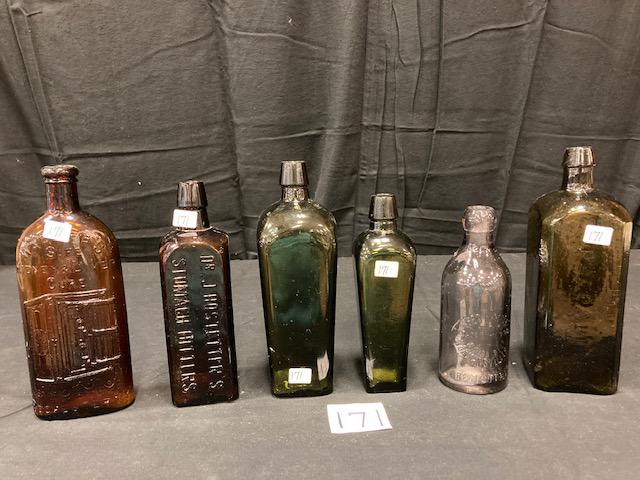 Collection of Six Antique Bottles: Collection of six antique bottles. One Warriors Safe Kidney and Liver Cure, Rochester, NY with embossed safe. Brown color. 9.5"h x 3.75"w x 1.75"d. One Dr. J. Hostetter;s Stomach Bitters, brown color.