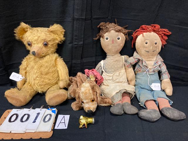 Four Cloth Dolls and Two Raggedy Ann Story Books: Four cloth dolls and two Raggedy Ann story books. One nice early 1900s jointed Mohair glass eyed teddy bear. Squeaker works sometimes when squeezed. 9"w x 14"l. One early 1900s glass eyed stuffed, met